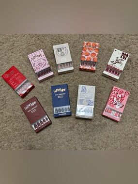 9 sets of brand new Red Aspen nails. Each box includes glue, a file & many sizes